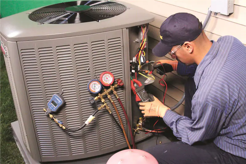 Technician servicing an outdoor air conditioner